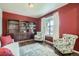 Cozy living room with rich-colored walls, built-in bookshelves, and large bright window at 853 Jenny Ln, Berthoud, CO 80513