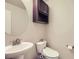 Cozy half bathroom featuring an oval mirror and pedestal sink at 853 Jenny Ln, Berthoud, CO 80513