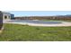 View of the community pool covered for the off-season, with a fence, grass lawn and mountain view at 853 Jenny Ln, Berthoud, CO 80513