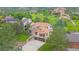 An aerial view shows a charming two-story home with an attached garage on a lush green property at 5569 Willow Springs Dr, Morrison, CO 80465