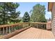 A relaxing backyard wooden deck with beautiful lush trees and mountain views at 5569 Willow Springs Dr, Morrison, CO 80465