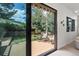 Tranquil backyard view through sliding glass door to wood deck and chairs at 5569 Willow Springs Dr, Morrison, CO 80465