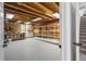 Unfinished basement area offering ample storage with exposed beams and shelving at 5569 Willow Springs Dr, Morrison, CO 80465