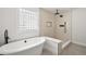 Bright bathroom featuring a freestanding tub and a gorgeous shower with frameless glass block window at 5569 Willow Springs Dr, Morrison, CO 80465