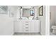 Bathroom showcasing double sinks, modern vanity, a decorative mirror, and stylish light fixtures at 5569 Willow Springs Dr, Morrison, CO 80465