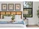 Bright bedroom featuring a decorative tray, accent pillows, a wood headboard, and a large picture window at 5569 Willow Springs Dr, Morrison, CO 80465
