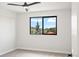 A bedroom with beautiful mountain views through the window and a modern ceiling fan at 5569 Willow Springs Dr, Morrison, CO 80465