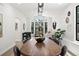 Bright dining room with a long dining table, black framed bay windows, and modern decor at 5569 Willow Springs Dr, Morrison, CO 80465