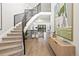 Bright entryway featuring a curved staircase with black metal railing and light wood floors at 5569 Willow Springs Dr, Morrison, CO 80465
