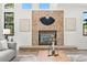 Close-up of brick fireplace with decorative mantle and hearth in living area at 5569 Willow Springs Dr, Morrison, CO 80465