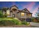 Charming two-story home with lush landscaping, brick facade, and attached two-car garage at 5569 Willow Springs Dr, Morrison, CO 80465