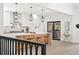 Kitchen island with white cabinets, modern pendant lights, and view of the backyard and outdoor patio at 5569 Willow Springs Dr, Morrison, CO 80465