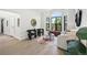 Bright living room with black framed bay windows, modern decor, and light wood floors at 5569 Willow Springs Dr, Morrison, CO 80465