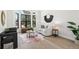 Bright living room with curved chair, modern decor, bay windows, and light wood floors at 5569 Willow Springs Dr, Morrison, CO 80465