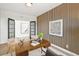 Home office with modern desk, textured wall, and French doors to hallway at 5569 Willow Springs Dr, Morrison, CO 80465