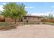 Rear exterior features a mix of brick and siding, surrounded by spacious parking at 7961 Granada Rd, Denver, CO 80221