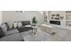 Finished basement area boasts a modern fireplace, stylish decor, and comfortable seating at 7961 Granada Rd, Denver, CO 80221