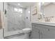 Updated bathroom featuring elegant marble tile, modern fixtures, and a sleek glass shower at 7961 Granada Rd, Denver, CO 80221