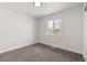Cozy bedroom features plush carpeting and a bright window with natural light at 7961 Granada Rd, Denver, CO 80221
