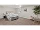 Stylish bedroom with a plush bed, accent chair, and comfortable carpeting at 7961 Granada Rd, Denver, CO 80221
