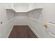 Walk-in closet with neutral carpeting, shelves, and space for ample storage at 7961 Granada Rd, Denver, CO 80221