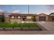Charming single-story home with well-manicured lawn and an inviting, detached garage in a quaint neighborhood at 7961 Granada Rd, Denver, CO 80221