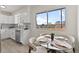 Bright and airy kitchen nook featuring modern cabinetry, stainless steel appliances, and stylish dining set at 7961 Granada Rd, Denver, CO 80221