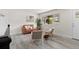 Tastefully designed living room with modern decor, including a leather sofa, chairs and stylish area rug at 7961 Granada Rd, Denver, CO 80221