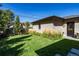 Manicured backyard with a brick house, lawn and landscaping at 2409 S Fillmore St, Denver, CO 80210
