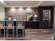 Finished basement bar area with exposed brick and wine cellar at 2409 S Fillmore St, Denver, CO 80210
