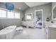 Spa-like bathroom with a freestanding tub, marble floors, and designer fixtures at 2409 S Fillmore St, Denver, CO 80210