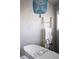 Bathroom showcasing a standalone tub with towel ladder and stylish chandelier at 2409 S Fillmore St, Denver, CO 80210