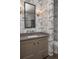 Stylish powder room with custom wallpaper and a modern vanity at 2409 S Fillmore St, Denver, CO 80210