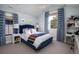 Bright bedroom with blue accents, patterned curtains, and a dedicated workspace at 2409 S Fillmore St, Denver, CO 80210