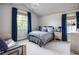 Comfortable bedroom with a patterned bedspread, bedside tables, and natural light at 2409 S Fillmore St, Denver, CO 80210