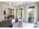 Bright dining room with a large wood table, statement chandelier, and ample natural light at 2409 S Fillmore St, Denver, CO 80210