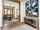 Elegant foyer with beautiful hardwood floors, a decorative table, and stunning artwork creating a welcoming atmosphere at 2409 S Fillmore St, Denver, CO 80210