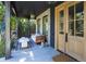Cozy front porch with a comfortable cushioned bench, stylish accent pieces, and a view of the lush surrounding greenery at 2409 S Fillmore St, Denver, CO 80210