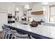 Open concept kitchen featuring a white marble island with seating and pendant lighting at 2409 S Fillmore St, Denver, CO 80210