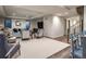 Spacious basement living room with comfortable seating, TV, and natural light at 2409 S Fillmore St, Denver, CO 80210