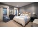 Comfortable main bedroom with a queen bed, stylish blue and white accents, and great natural light at 2409 S Fillmore St, Denver, CO 80210