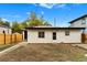 View of the back of the home with a door and windows at 3220 W 8Th Ave, Denver, CO 80204
