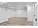 Bright basement area featuring vinyl flooring, neutral carpet and white walls at 3220 W 8Th Ave, Denver, CO 80204