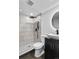 This full bathroom offers a walk-in shower with black fixtures, sleek tile, and stylish vessel sink at 3220 W 8Th Ave, Denver, CO 80204