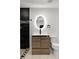 A bathroom with a modern vanity and a built-in backlit mirror adjacent to a tile shower at 3220 W 8Th Ave, Denver, CO 80204