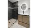 This bathroom features a modern vanity with a backlit mirror next to a tile shower at 3220 W 8Th Ave, Denver, CO 80204