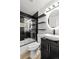 Modern bathroom with black and white tile, unique sink and vanity, shelving and stylish mirror at 3220 W 8Th Ave, Denver, CO 80204
