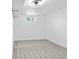 Bedroom with neutral carpet, white walls, trim and a modern ceiling light at 3220 W 8Th Ave, Denver, CO 80204