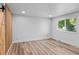 A bedroom is adorned with plank flooring and a custom wood accent wall at 3220 W 8Th Ave, Denver, CO 80204
