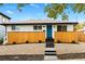 Charming home featuring a bright blue door, modern landscaping, and a freshly painted exterior at 3220 W 8Th Ave, Denver, CO 80204